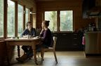 A couple sitting and chatting at a kitchen table in a new home