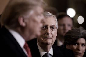 Senator Mitch McConnell looking at President Trump while the president speaks
