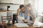 Husband and wife home budgeting at kitchen table