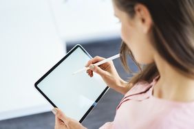 woman using tablet with stylus