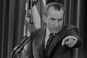President Richard Nixon points at a reporter during a press conference.